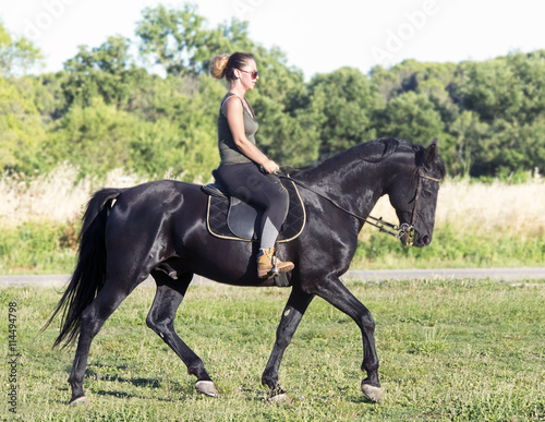 riding girl on black stallion © cynoclub