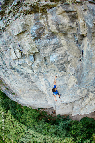 male rock climber. rock climber climbs on a rocky wall © vitaliymateha