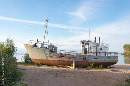 rusty old ship on the shore © Ekaterina Elagina