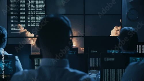 Group of People in Mission Control Center filled with Displays, Celebrating Successful Rocket Launch. Elements of this image furnished by NASA photo