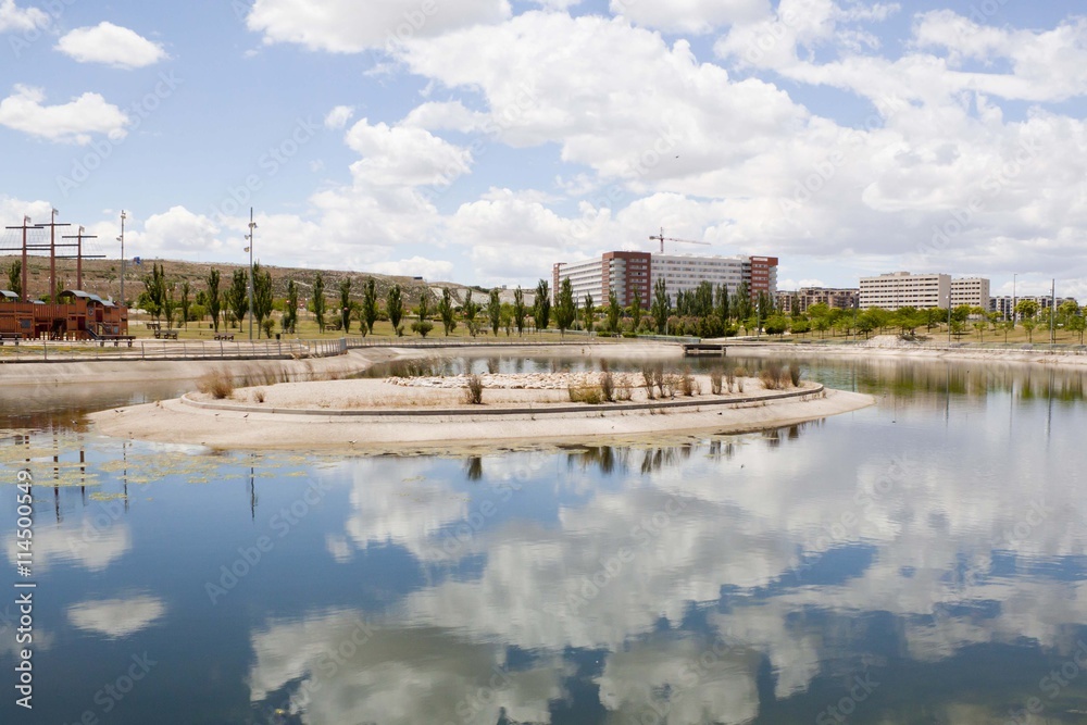 clouds over a lake, a park and an urbanization in Zaragoza