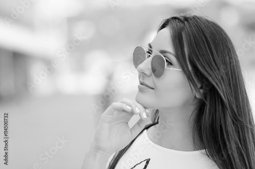 Portrait of a smiling stylish woman in city