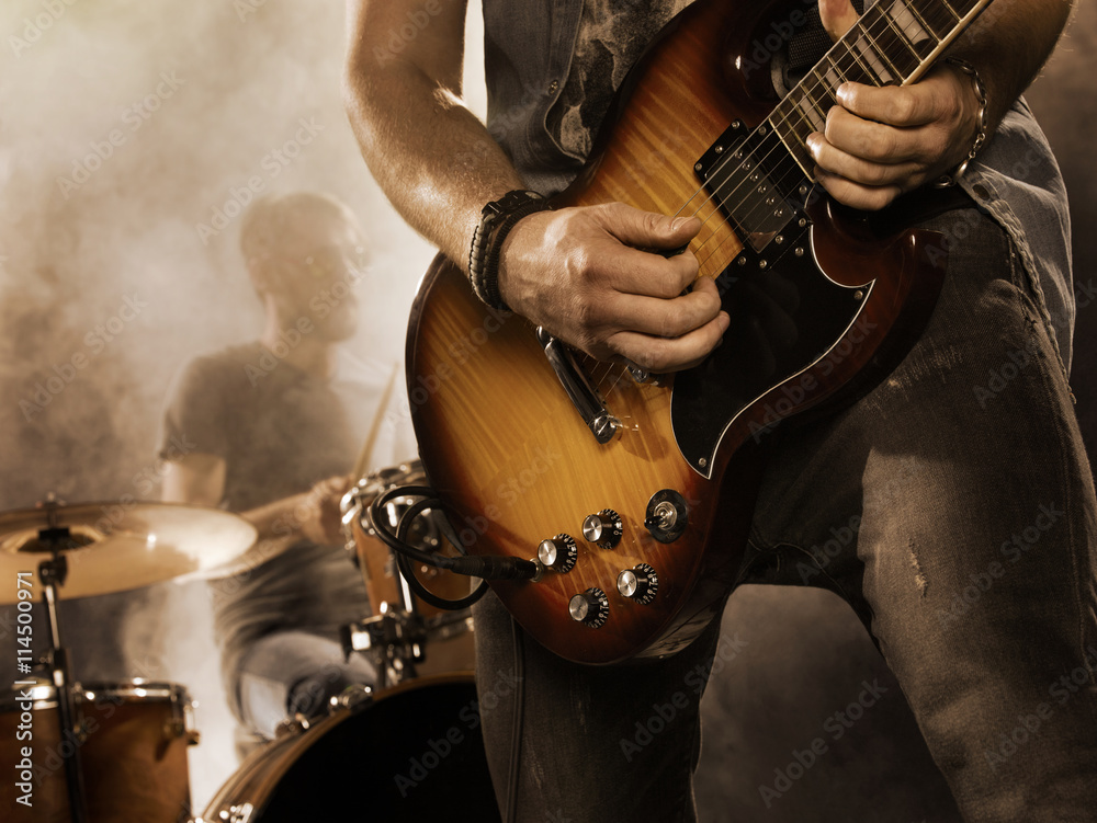 Obraz premium Rock band performs on stage. Guitarist.