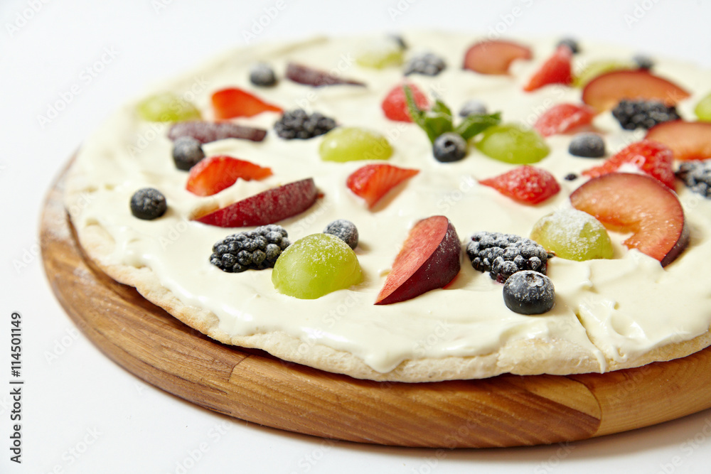 Sweet pizza with fruits and berries on white background