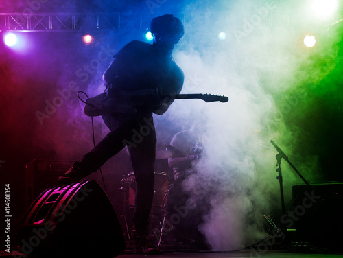 Silhouette of guitar player on stage. © Voloshyn Roman