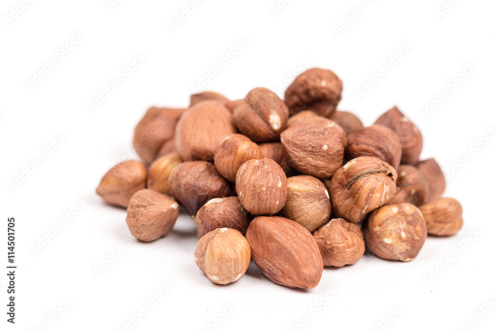 Pile of raw hazelnuts over white background Pile of raw hazelnuts over white background