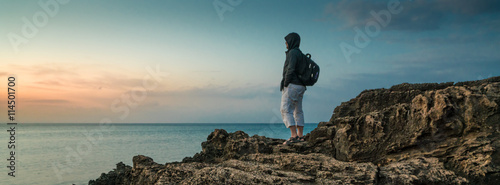 Young traveler on a rock
