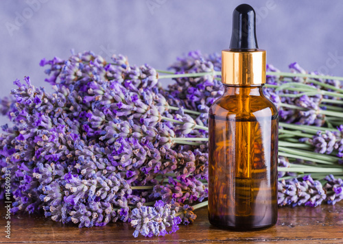 Lavender oil bottle on wood background.Essential oil, natural remedies.