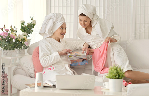 women wearing a white bathrobes with laptop