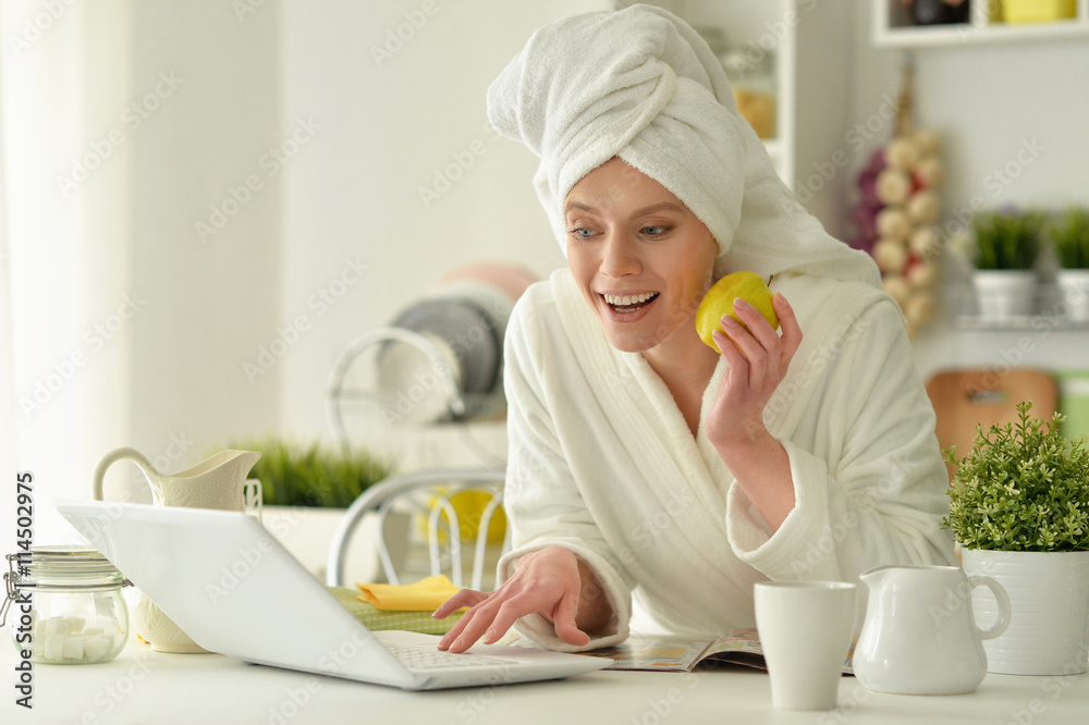 woman wearing a white bathrobe with laptop woman wearing a white bathrobe with laptop