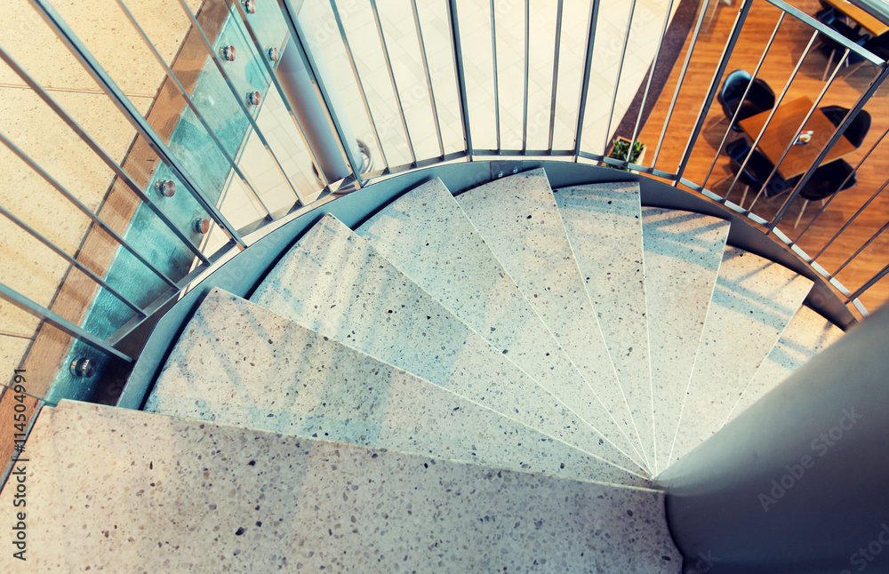 Fototapeta premium close up of stone spiral staircase at restaurant
