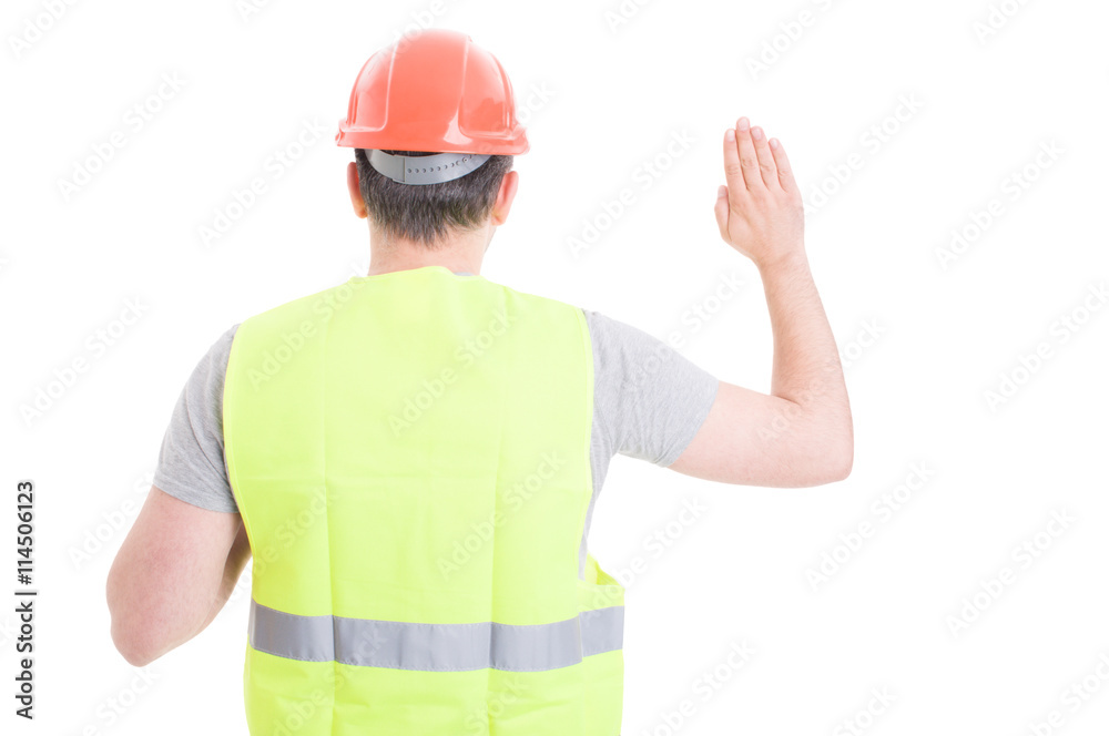 Back view of male constructor standing and doing a vow