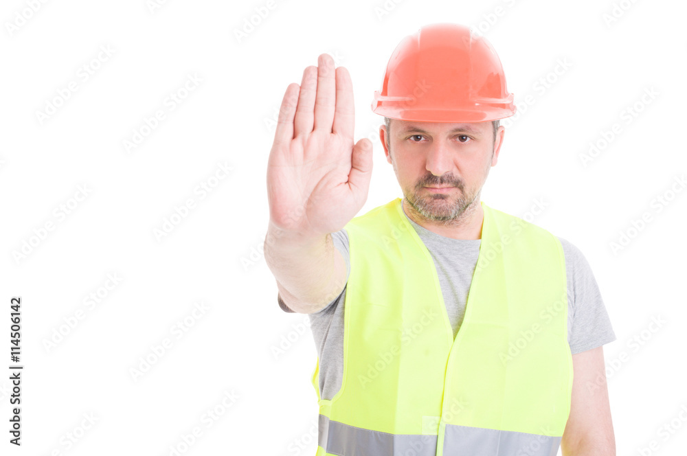 Constructor in protection equipment doing stop gesture