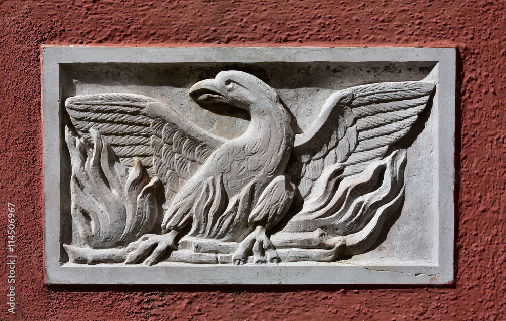 Fototapeta premium Phoenix Theatre Sign. Old Patera (Venice public art) with phoenix theatre symbol on a wall near the famous opera house