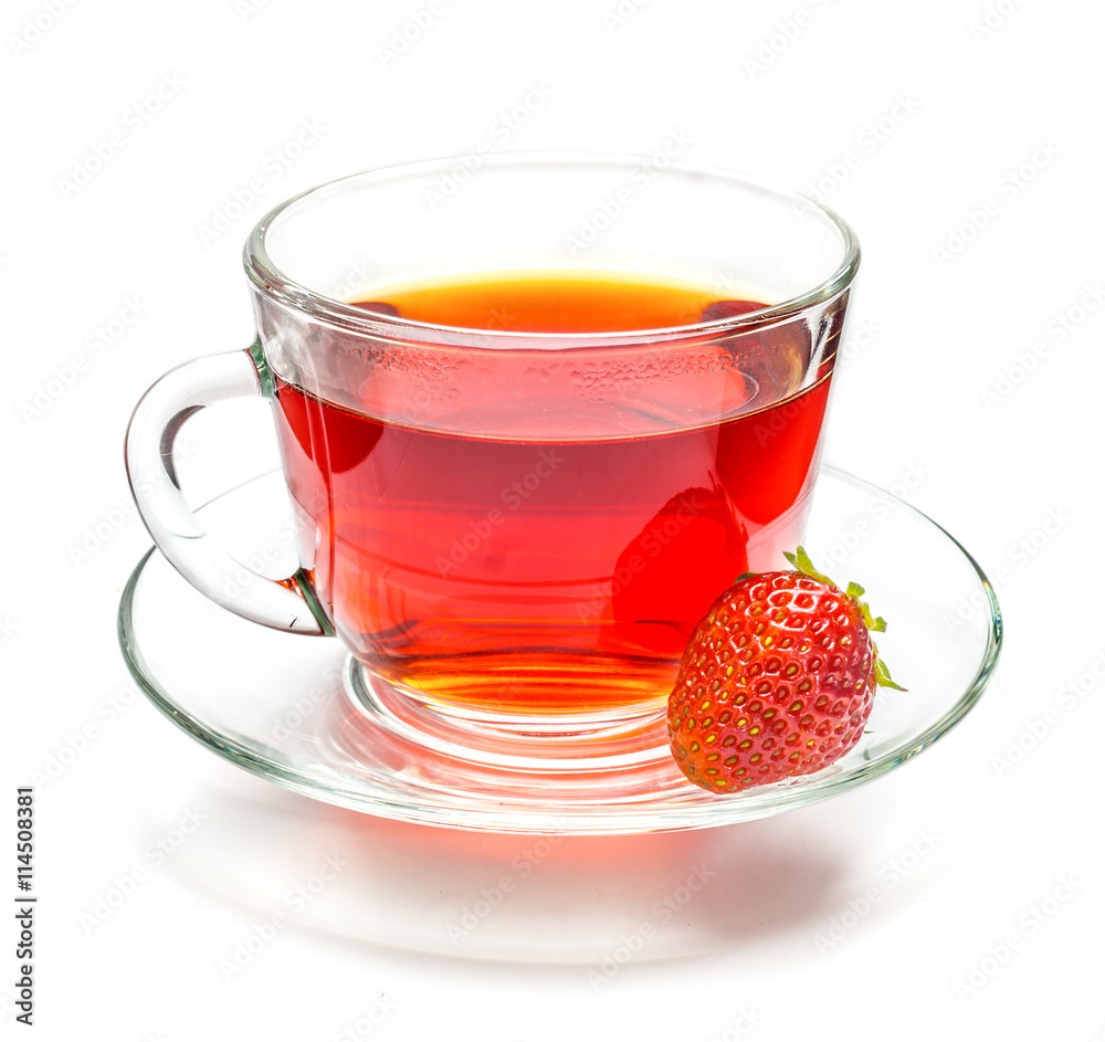 Transparent cup of tea and strawberry on white