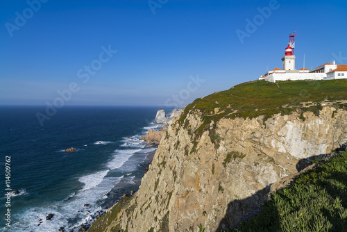 Cliffs and lighthouse of Cabo da Roca on the Atlantic Ocean in Sintra, Portugal, the westernmost point on the continent of Europe, where the land ends and the sea begins. © catuncia