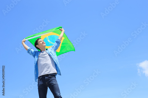 Excited man holding brazil flag