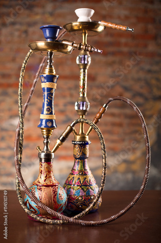 Eastern hookahs on wood table photo