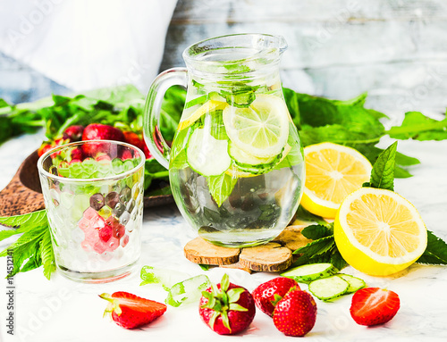 water-detox with lemon, strawberries and mint on light backgroun