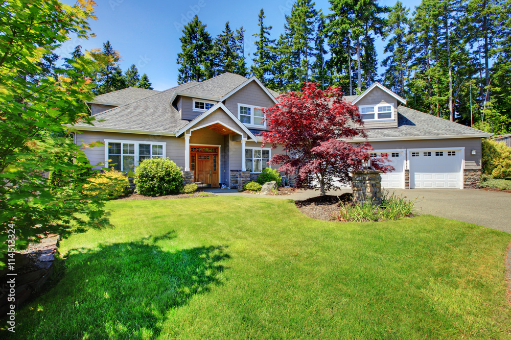 Beautiful curb appeal. Large beige house with white trim.