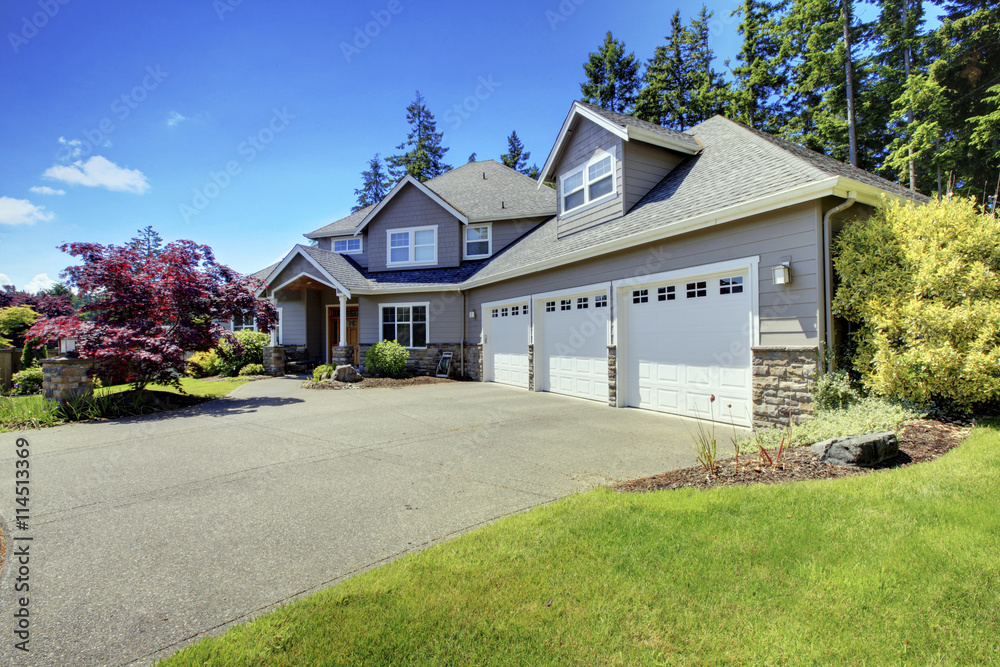 Luxury house exterior with french windows and three space parking garage. Luxury house exterior with french windows and three space parking garage.