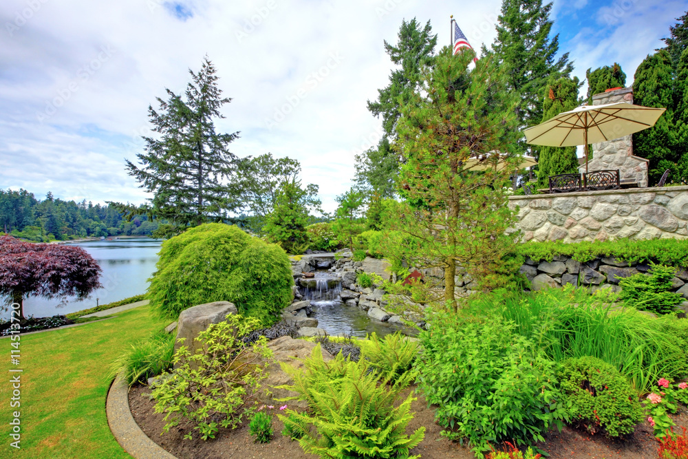 Backyard landscape with fountain and stone. Backyard landscape with fountain and stone.