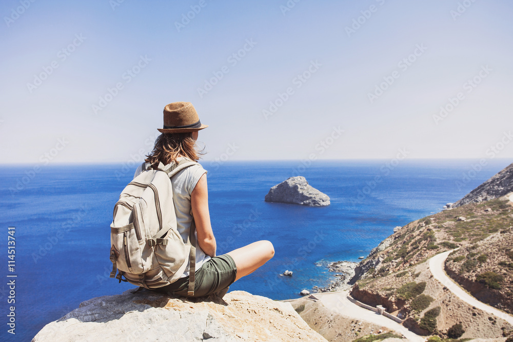 Female traveler looking at the sea, travel and active lifestyle concept