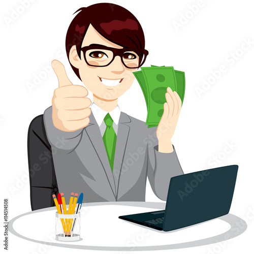 Successful businessman with green banknote money fan making thumbs up gesture sitting on office desk with laptop