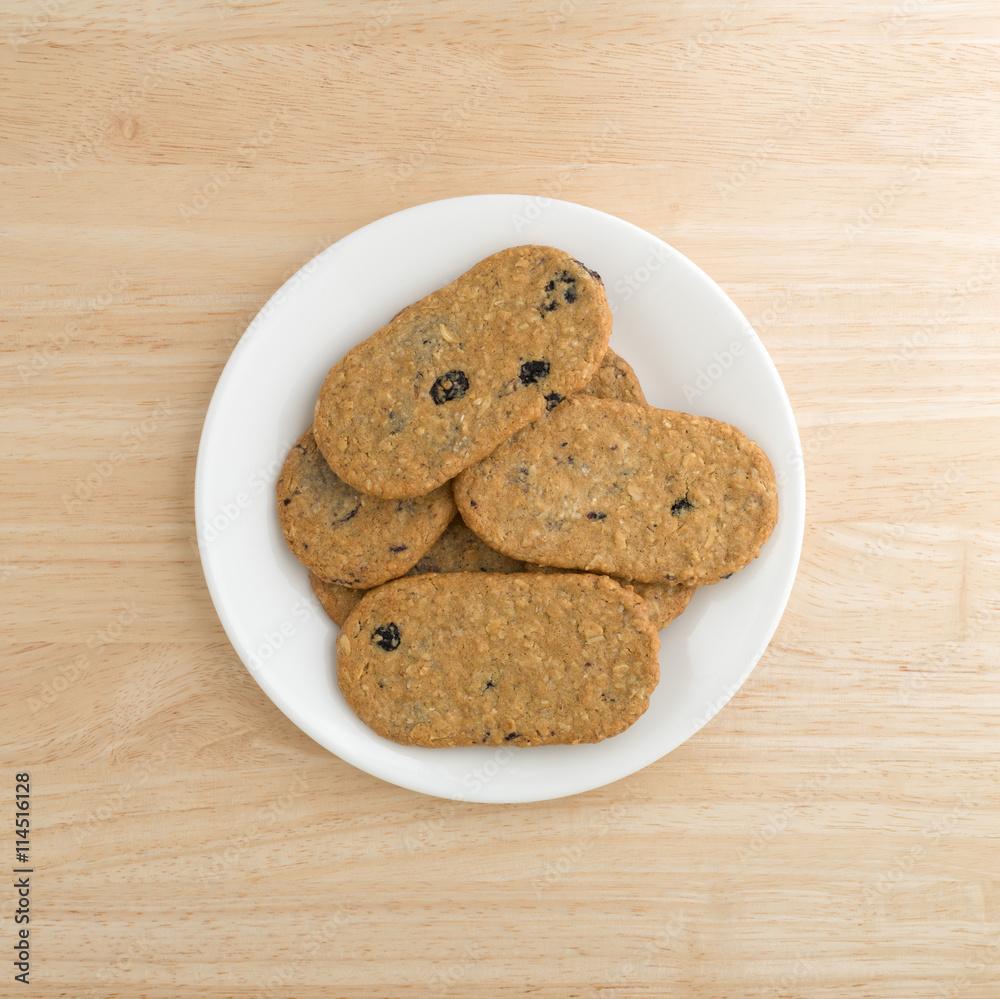 Blueberry wafer cookies on a white plate atop a wood table top view. Blueberry wafer cookies on a white plate atop a wood table top view.