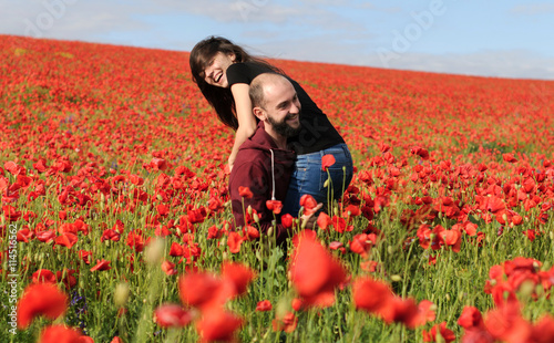 Young man and woman having date in the field of poppies © visochin_o