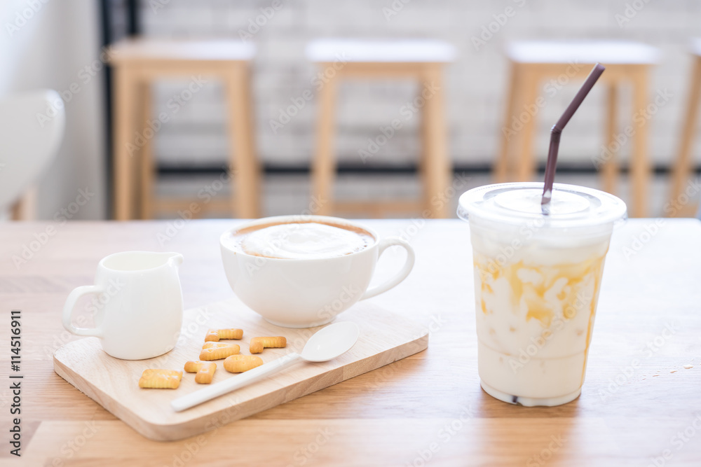 Cup of coffee and biscuit on wooden table