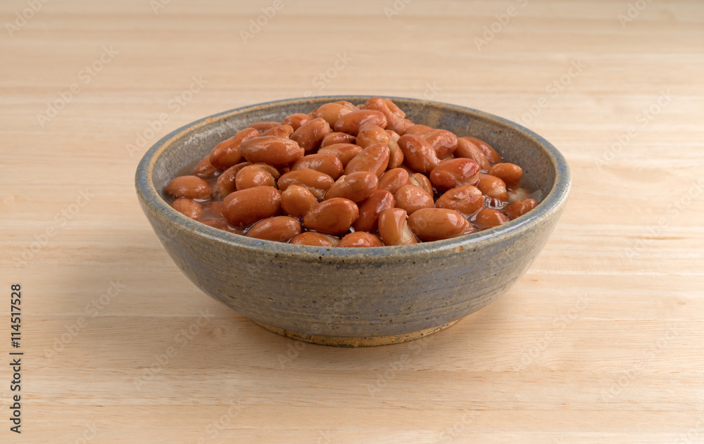 Bowl of shelled beans on a wood table side view. Bowl of shelled beans on a wood table side view.