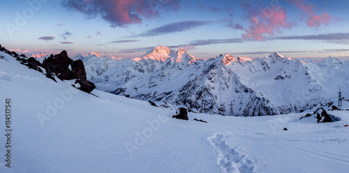 Beautiful spring sunset landscape in the snow capped mountains