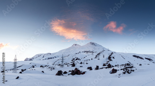 Beautiful winter landscape with snow-covered mountain Elbrus at sunset.