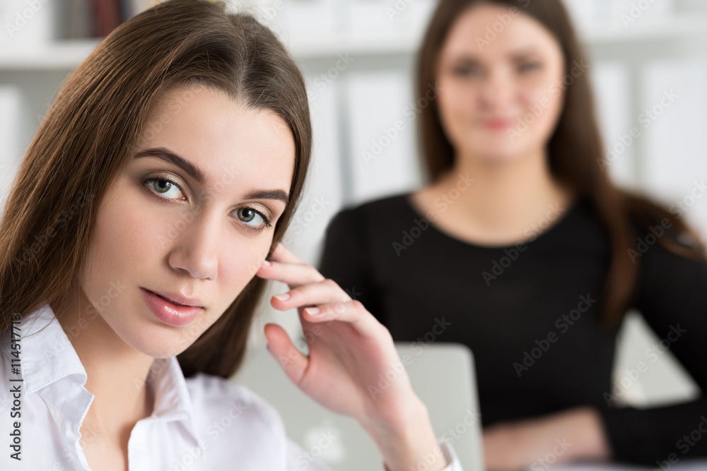 Two young business woman working at their office. Two young business woman working at their office.
