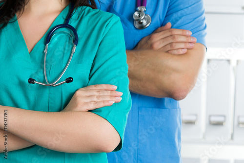 Two doctors standing with their arms crossed on chest