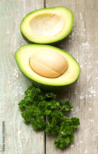 Avocado and parsley on a wooden background