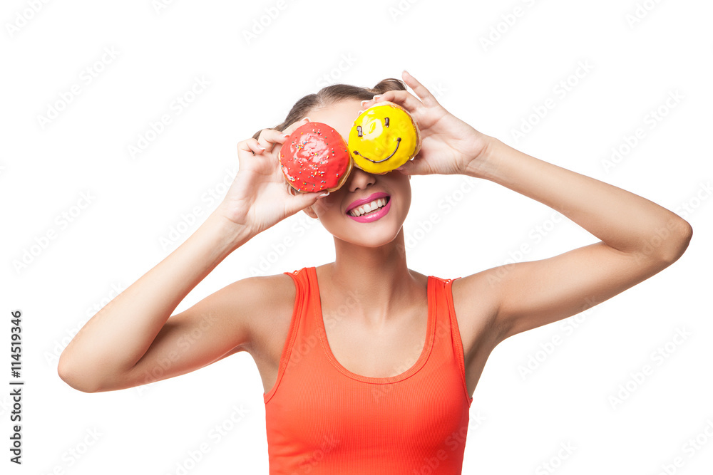 Young smiling woman covering eyes with donuts Young smiling woman covering eyes with donuts