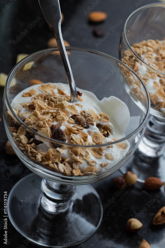 Granola with yoghurt, nuts and fruits in glass bowl on dark background. Delicious, healthy sweet dessert for breakfast. Cereal, muesli. Copy space, closeup.
Granola with yoghurt, nuts and fruits in glass bowl on dark background. Delicious, healthy sweet dessert for breakfast. Cereal, muesli. Copy space, closeup.