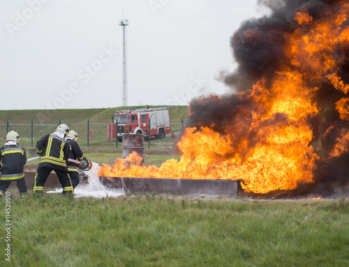 Fighting fire with a foam extinguisher photo