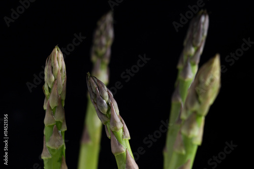 Bunch of asparagus on a table. Uncooked pile raw for organic, vegetarian cuisine, delicious fresh, healthy ingredient. Closeup and copy space.