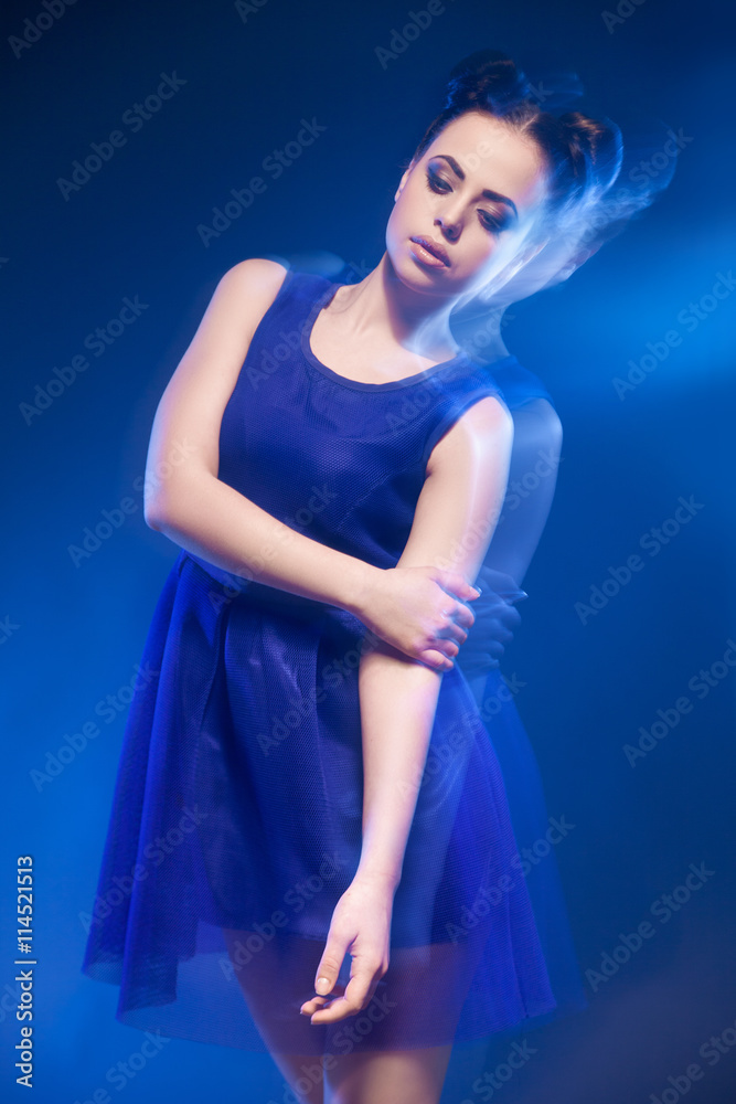 Woman in blue dress with hairstyle and make-up Woman in blue dress with hairstyle and make-up