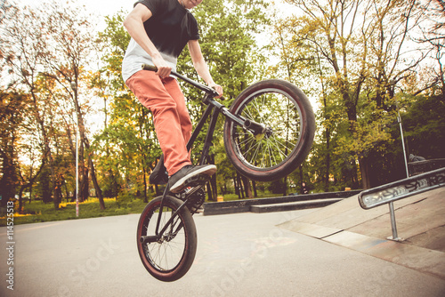 Young man jumping on a BMX.