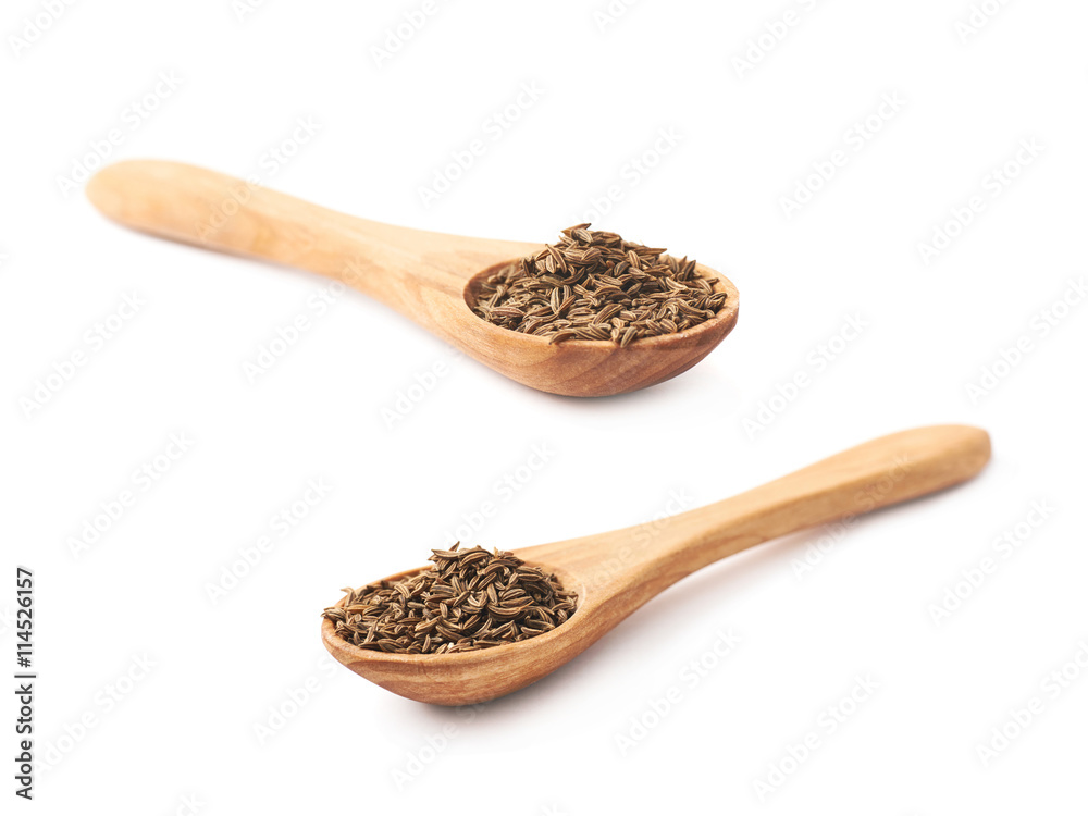 Wooden spoon full of cumin seeds Wooden spoon full of cumin seeds