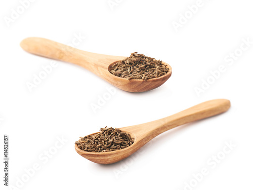 Wooden spoon full of cumin seeds