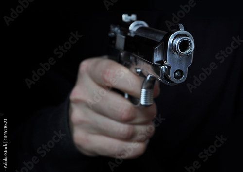 Man holding metal gun