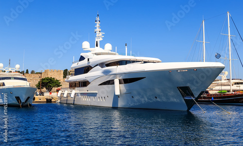 large white modern motor superyacht in port city of Rhodes Greece