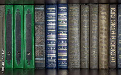 background of different books standing on a shelf