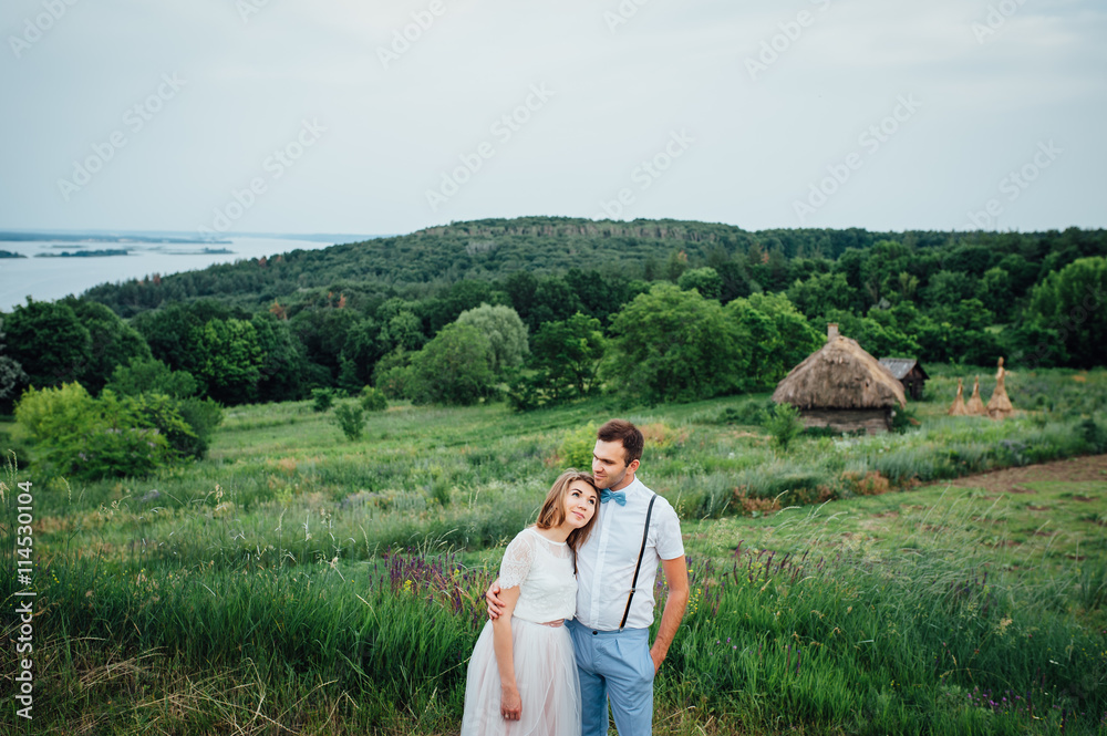 Happy Bride and groom walking on the green grass Happy Bride and groom walking on the green grass