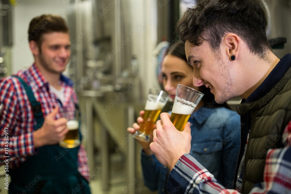Brewers testing beer at brewery factory Brewers testing beer at brewery factory